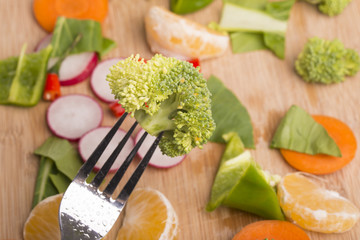 Different fruits and vegetables on wooden table