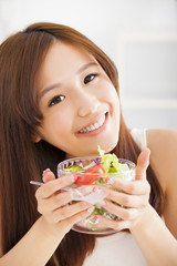 beautiful asian young woman eating salad