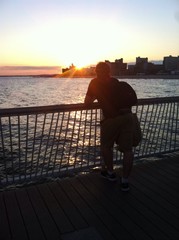 man at sunset on Coney Island