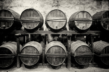 Barrels stacked in the winery in black and white