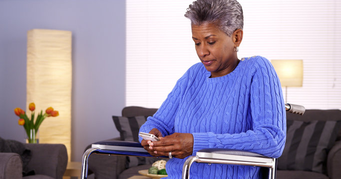 Mature Black Woman Texting On Smartphone