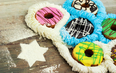 bright donuts on wooden background