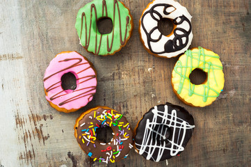 bright donuts on wooden background