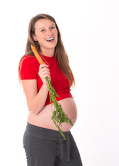 young pregnant woman is eating carrot