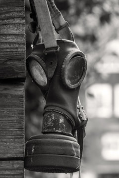 Outdated gasmask  on a wooden wall in black white