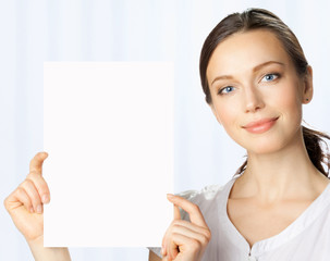 Businesswoman showing blank signboard, at office