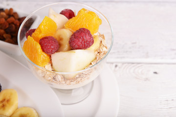 Muesli with fruits and berries on wooden table