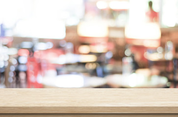 Empty wood table and blurred cafe with bokeh light background