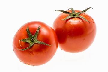 tomatoes with green leaves isolated on white background