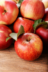 Ripe red apples on wooden background
