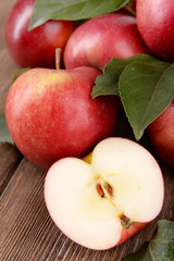 Ripe red apples on wooden background