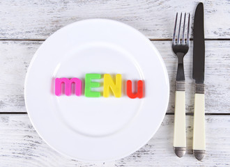 Inscription menu on plate on table close-up