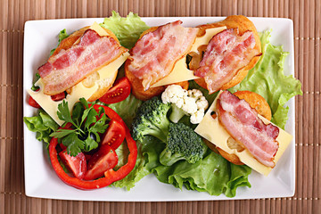 Serving breakfast toast with bacon and herbs