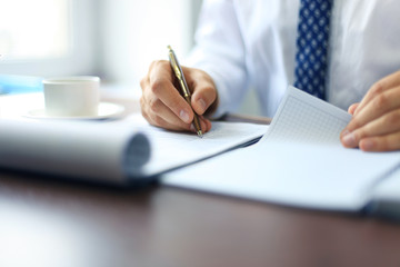 Businessman taking business notes at office