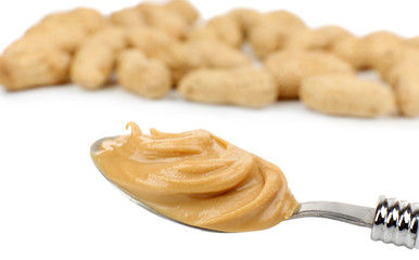 Creamy peanut butter in spoon, close-up