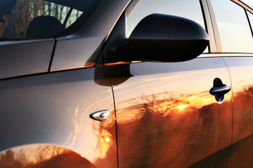 car sunset reflection