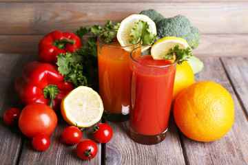 Carrot and tomato juice in glasses and fresh vegetables