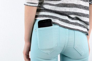 Smart phone in pocket jeans close-up