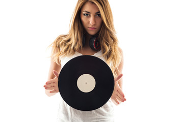 Portrait of a young woman holding a vinyl record against white b