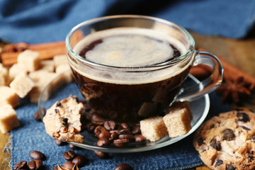 Cup of coffee and chocolate chip cookies on wooden background