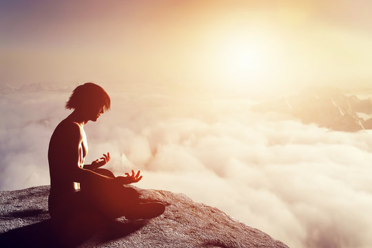Asian Man Meditates In Yoga Position In Mountains At Sunset