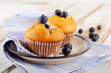 Homemade Muffins with  blueberries on a  wooden table