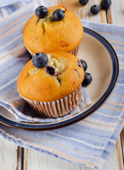 Homemade Muffins with  blueberries on   wooden table