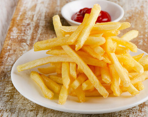 French fries on  wooden table
