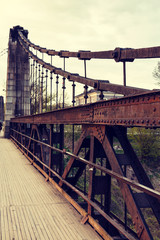 old rusty steel suspension bridge