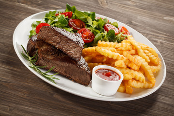 Grilled steak, French fries and vegetables