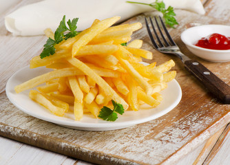 French fries on a wooden board
