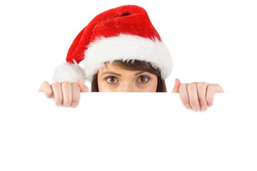 Festive brunette holding a poster