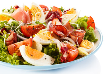 Boiled eggs with smoked ham and vegetables