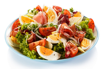 Boiled eggs with smoked ham and vegetables