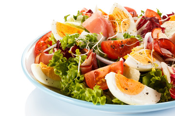 Boiled eggs with smoked ham and vegetables