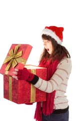 Festive brunette opening a gift