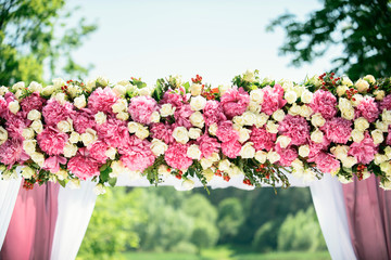 Part of wedding arch with pink and white flowers