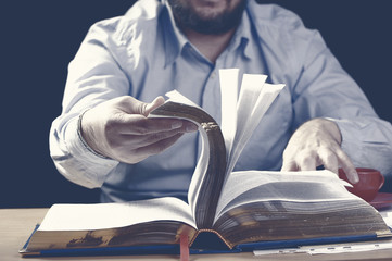 man looking for information in the book