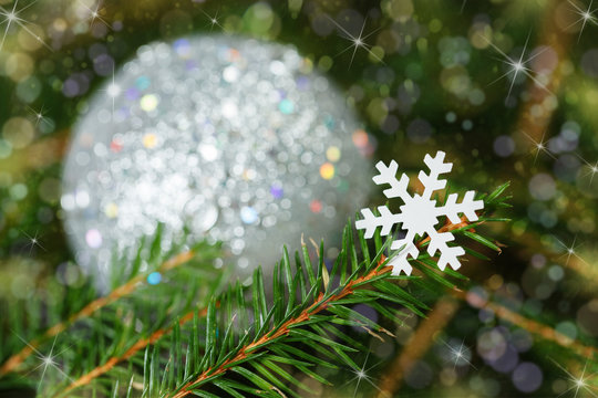snowflake on a fir-tree branch. Christmas card.