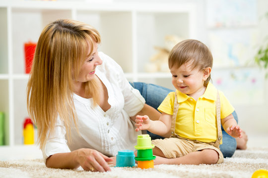 little child and woman playing  with toys