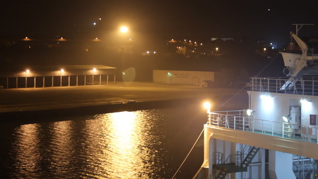 night lights illuminate the  seaport  and cargo ship