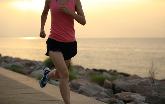 woman runner athlete running at seaside