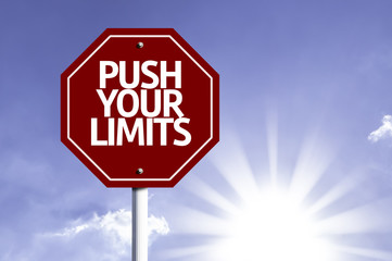 Push your Limits written on red road sign
