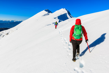 Fototapeta na wymiar Mountaineers walking on the Kosuta ridge in Karavanke range