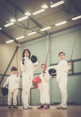 Obraz premium Children fencers and their trainer