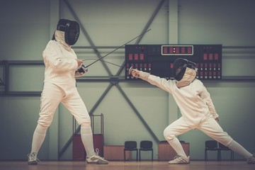 Little girl fencer and her trainer