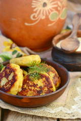 potato patties with fried  bacon  and onions.