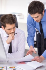 two businessmen having discussion in office.