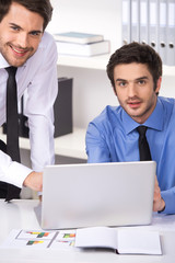 two businessmen having discussion in office.