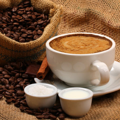 Fresh cup of black coffee with milk and sugar